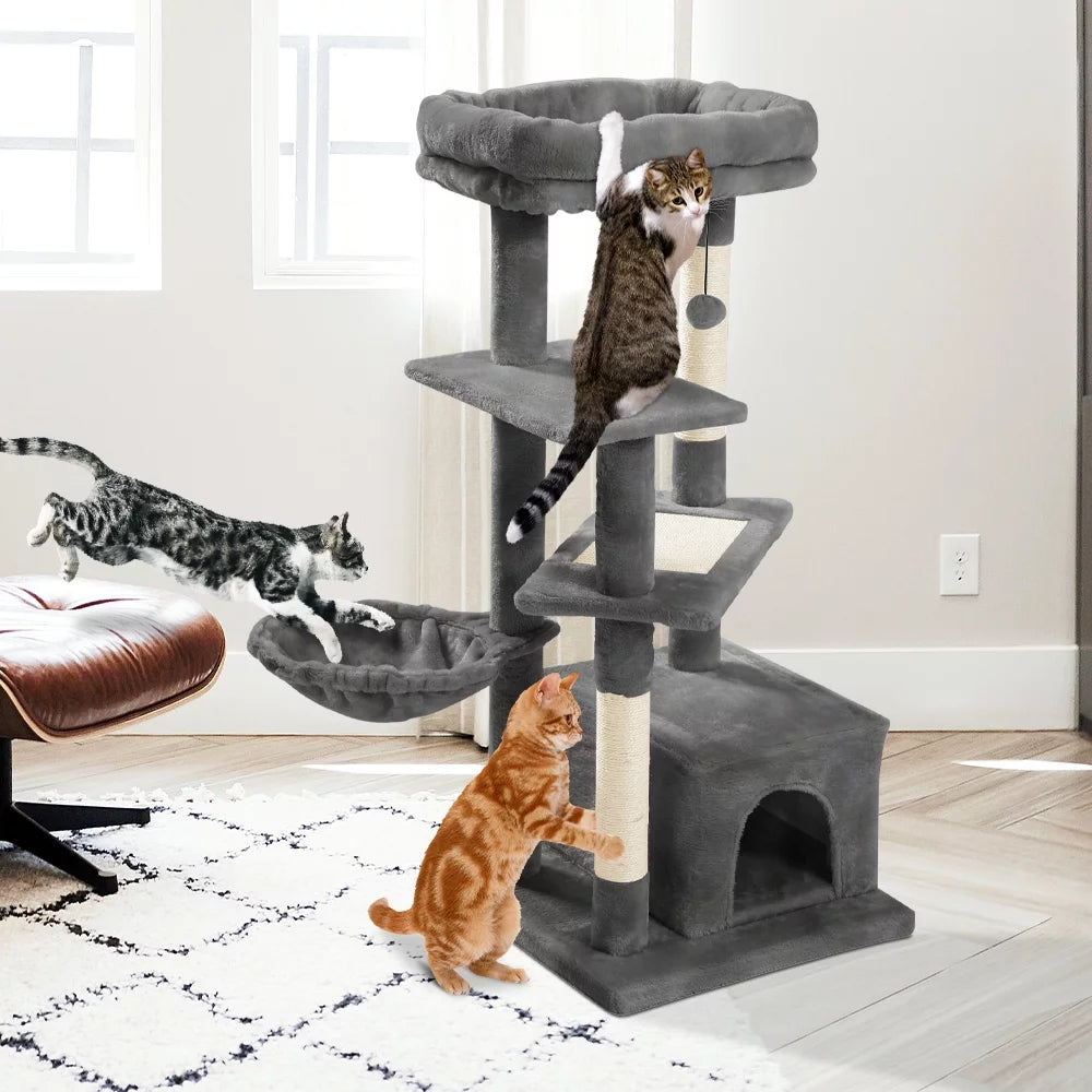 Gray multi-level cat tower with hammock featuring three cats playing and climbing in a bright living room