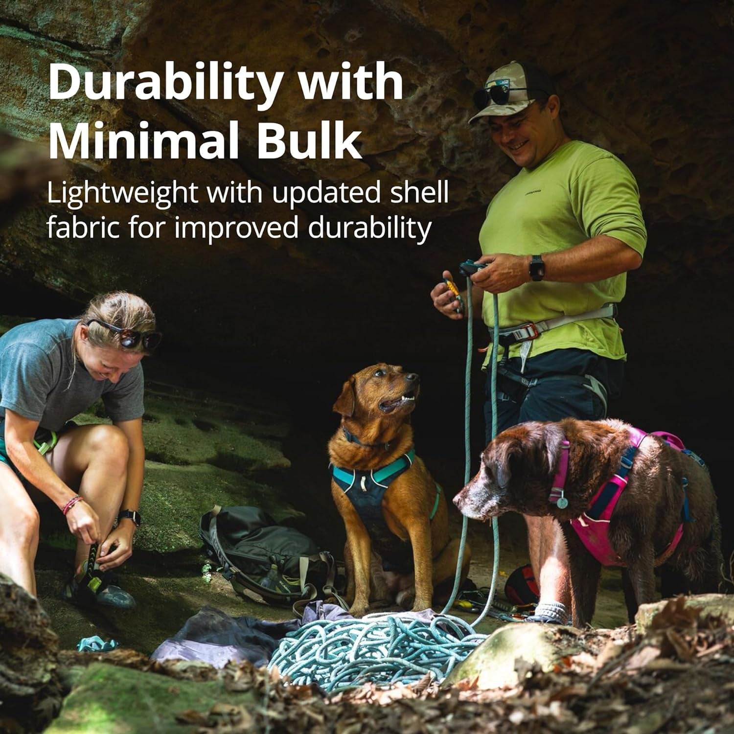 Hikers with two dogs wearing reflective no pull dog harness in a rocky campsite showcasing durable lightweight design