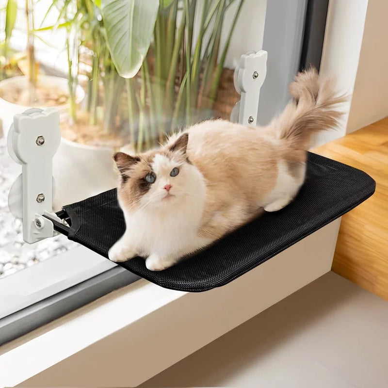 Foldable cat hammock seat mounted on a window sill with a fluffy white and brown cat relaxing